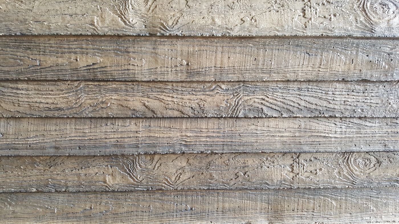 Concrete fencing on a property at dusk